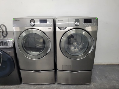 SAMSUNG GREY FRONT LOAD WASHER AND GAS DRYER SET WITH STEAM AND PESESTALS